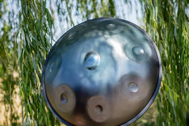 detail of a handpan, a metal percussion instrument on nature, copy space.