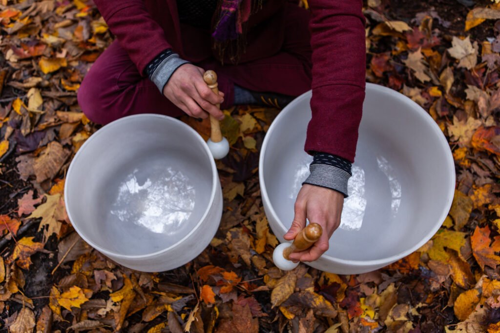 young,man,playing,crystal,bowls,outdoors,in,the,forest,while